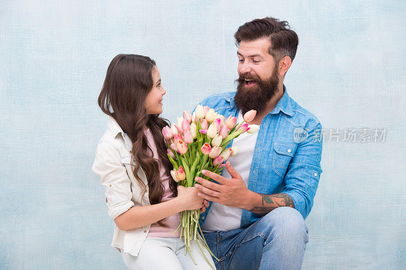 womens day celebration. kid and dad prepare flowers for mothers day. spring and beauty. father and daughter with flowers. Happy family portrait. girl greeting dad with Fathers Day